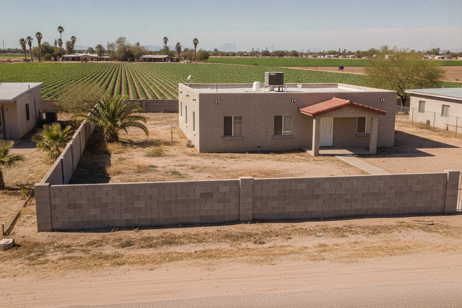 Retaining wall Somerton Arizona Yuma County agricultural area border wall flat desert residential property